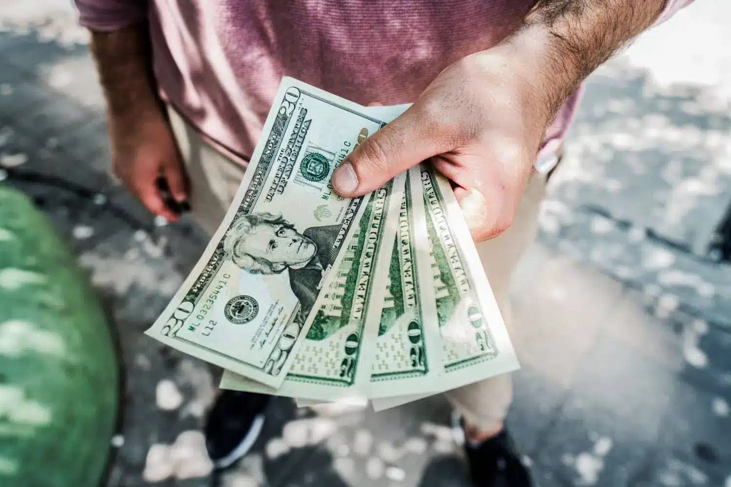 man holding $20 bills